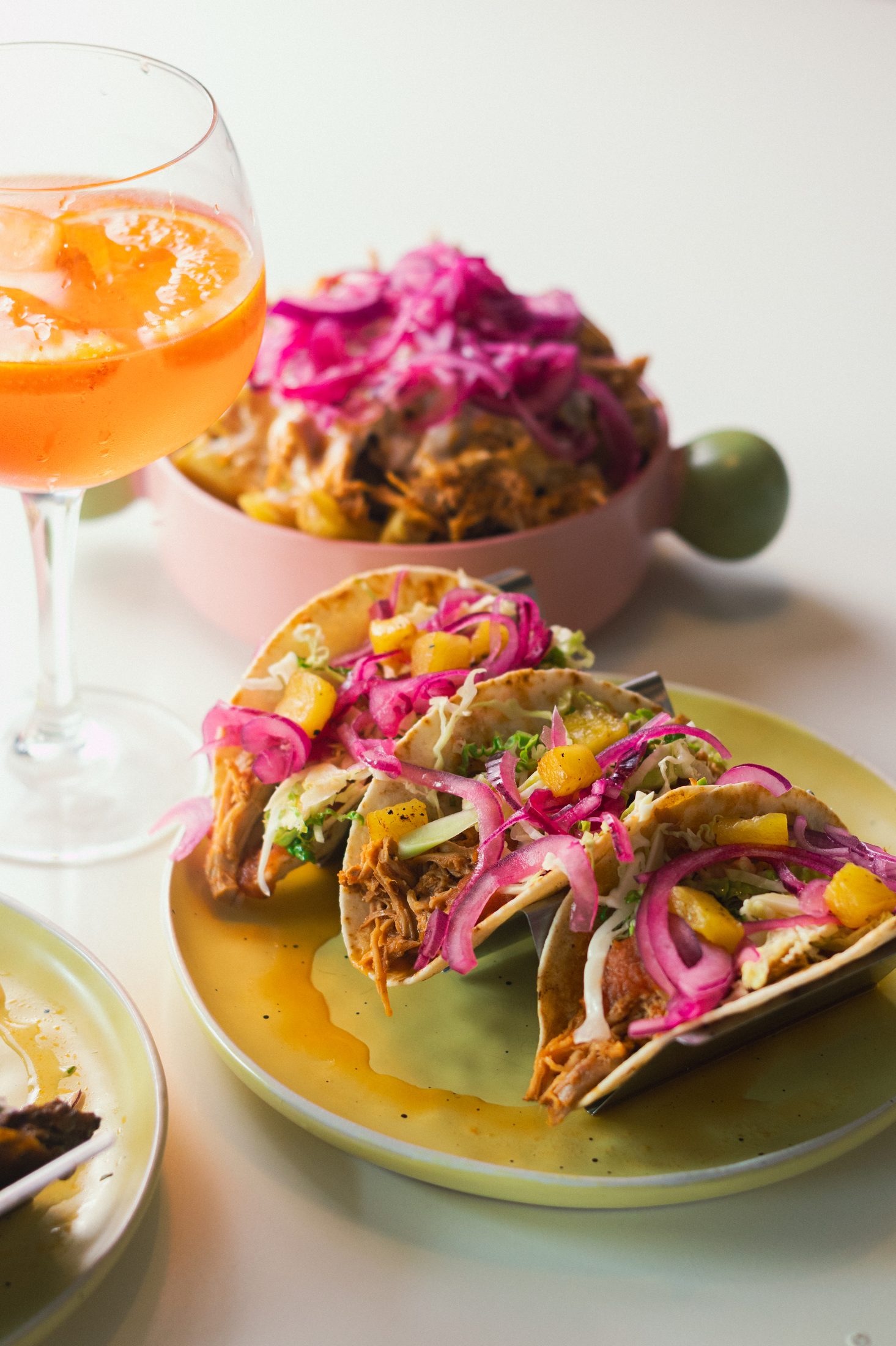 Slow-cooked pork tacos and loaded fries with pork, special sauce and pink onions at Cheat Day in Ericeira